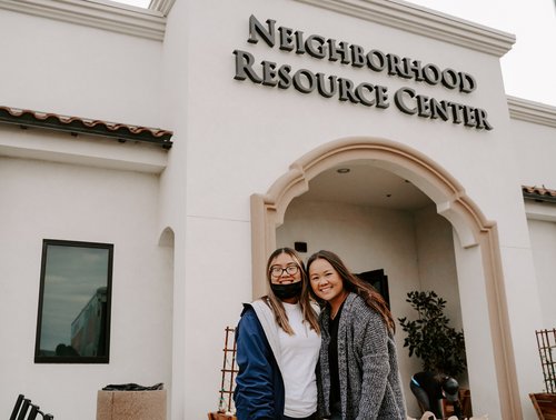 Two women outside the Neighborhood Resource Center