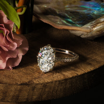 Custom oval diamond ring on a table