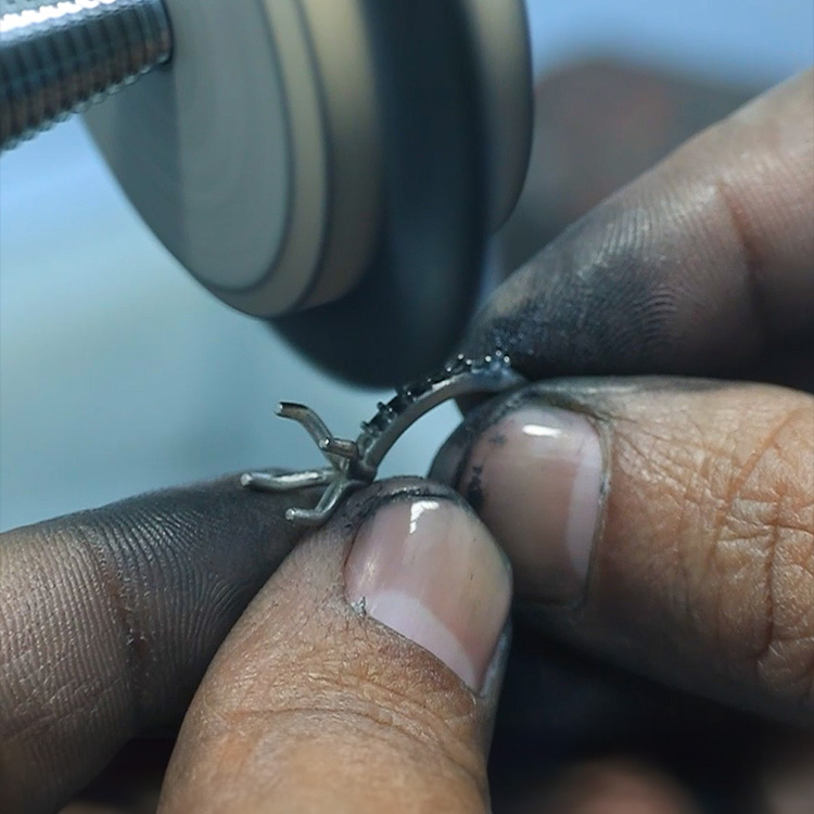 A custom jewelry ring being polished